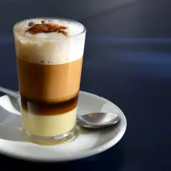 Ein geschichteter Kaffee mit Kondensmilch, Likör, Kaffee und Milchschaum, bestreut mit Zimt. Perfekt für ein Barraquito Rezept.